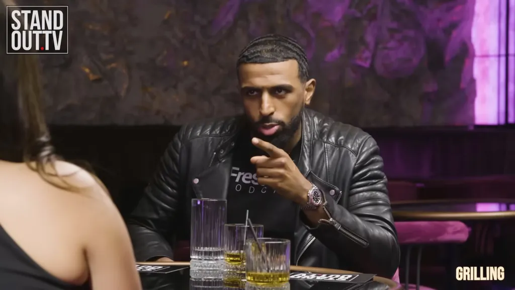 Myron Gaines speaking to a woman on a podcast