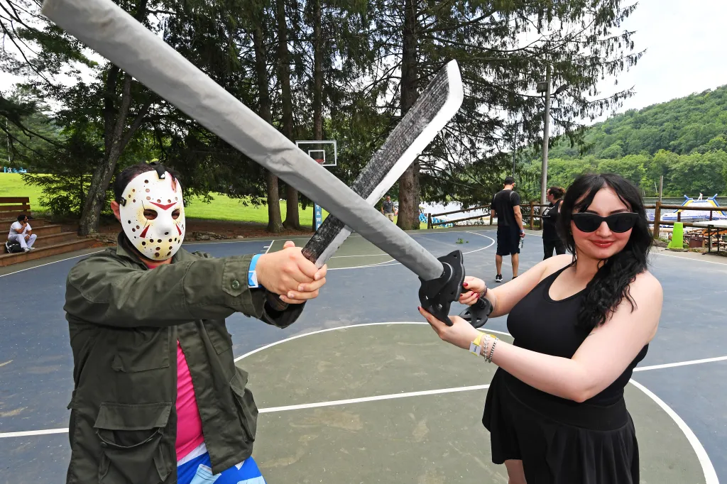 Marissa Matozzo sparring with a person in a Jason Voorhees mask on a basketball court at Camp Getaway.