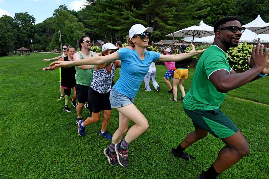 NY Post reporter Marissa Matozzo in a blue shirt and white cap participates in an adults-only camp activity at Camp Getaway in Kent, Connecticut.