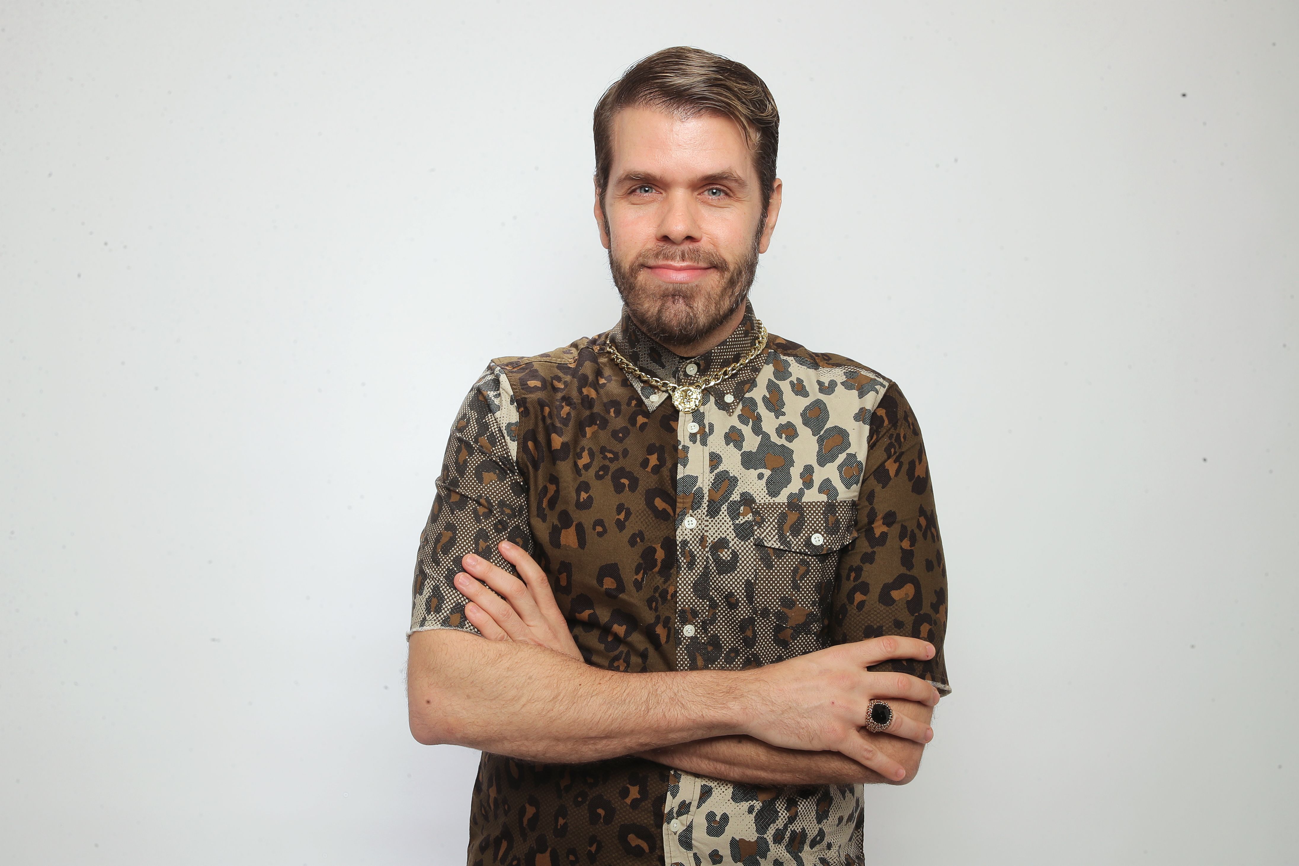Perez Hilton in a leopard print shirt and gold chain.