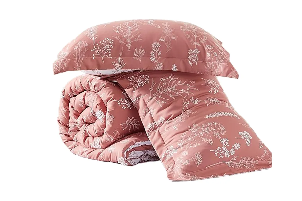 A pink blanket and pillow on a white background