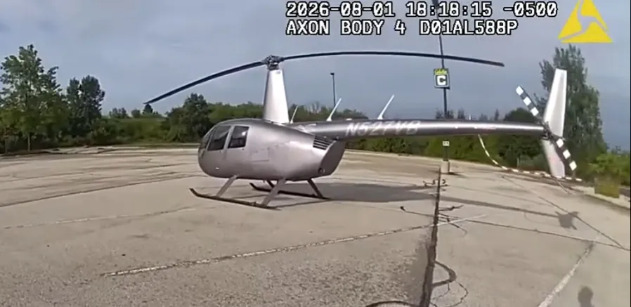 Body cam screenshot of a helicopter parked in a Cabela's parking lot.
