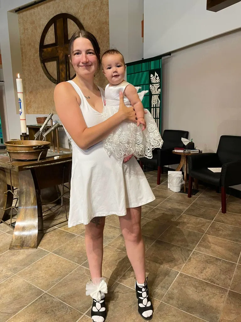 Kailey Erhart holding one of her children.