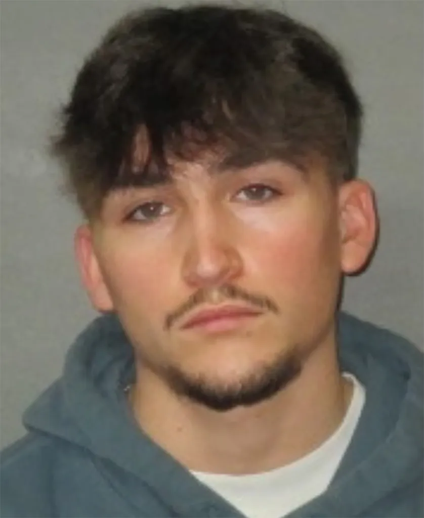 Mugshot of Casen Carver, an 18-year-old male with dark hair, light eyes, and a light mustache and beard.