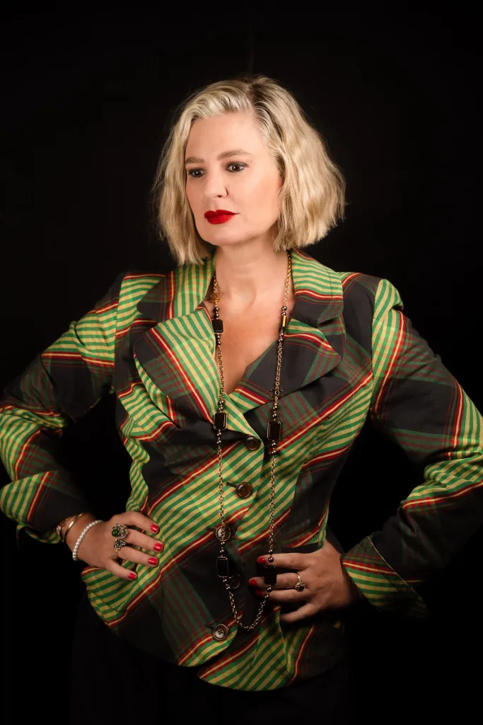 Christina Pazsitzky wearing a green, yellow, and red plaid blazer.