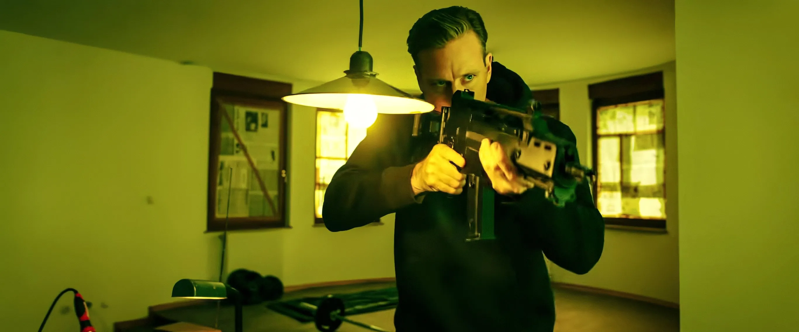 Armie Hammer as Citizen Vigilante, aiming a rifle.