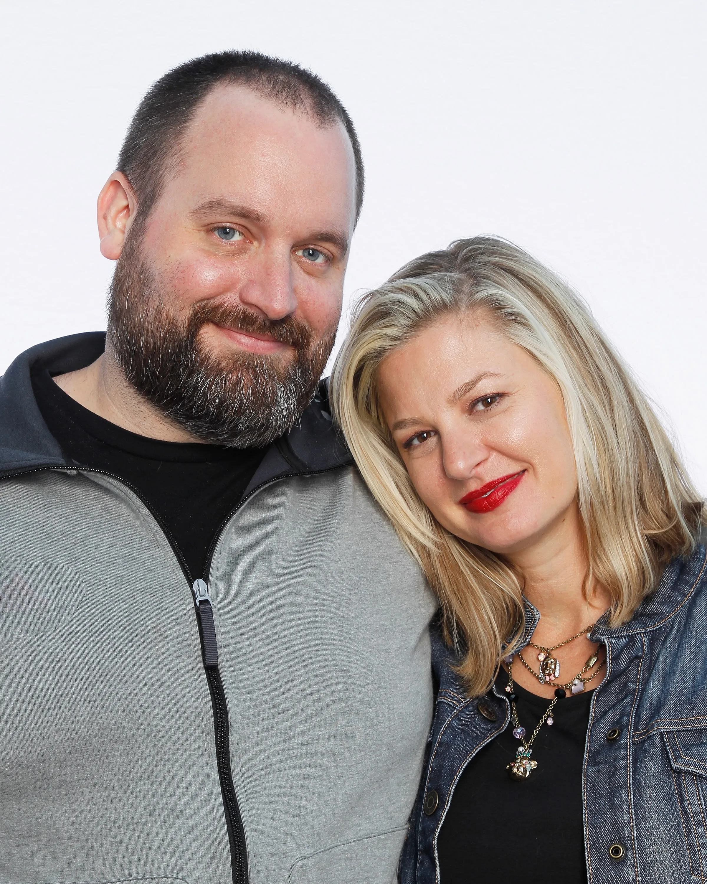 Comedian Tom Segura and comedian Christina Pazsitzky posing together.