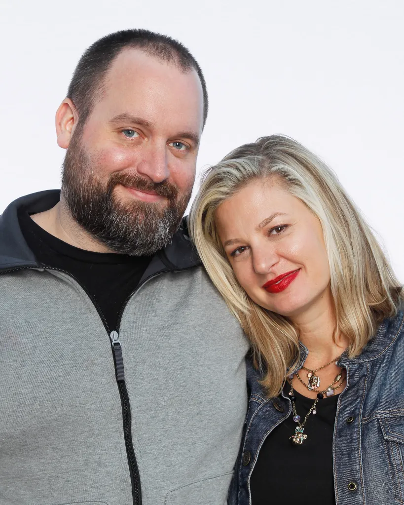 Comedians Tom Segura and Christina Pazsitzky posing together.