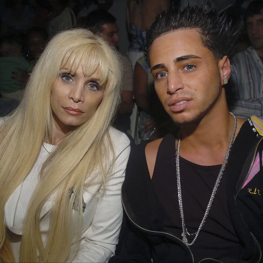Victoria Gotti poses with son Carmine at the Gillyard MFG show at Funkshion Fashion Week on March 23, 2006, in Miami Beach, Florida.