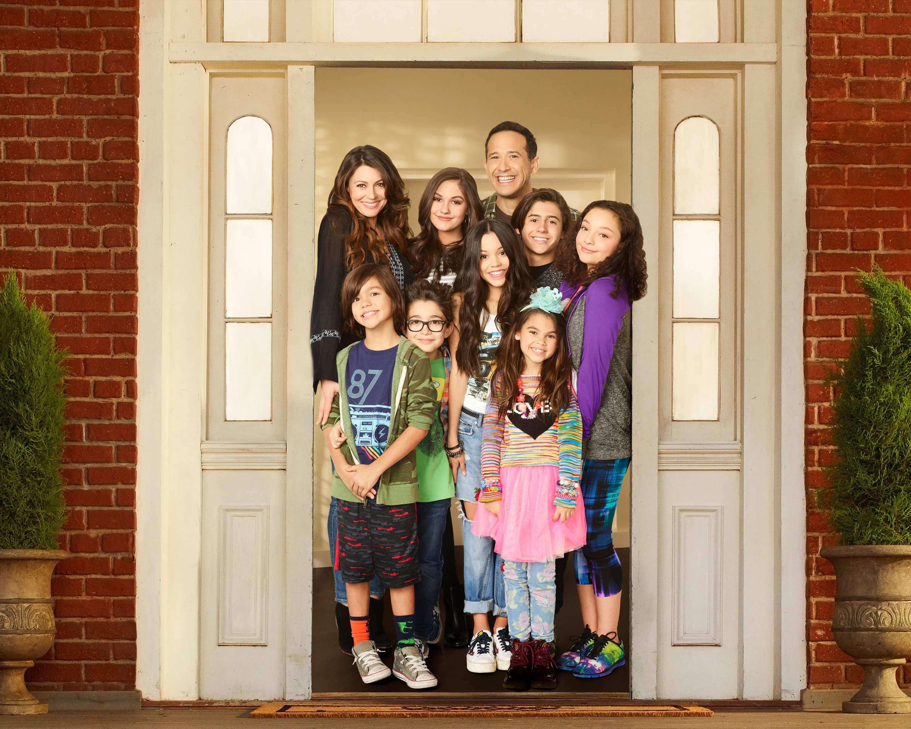 The cast of "Stuck in the Middle" poses together in a doorway.