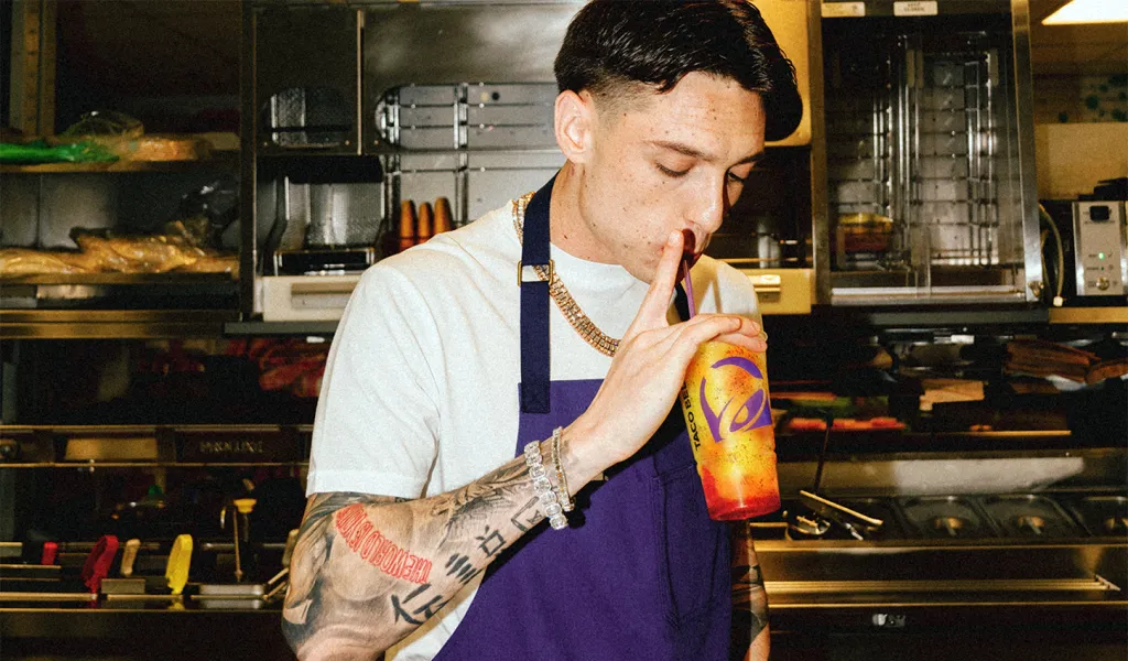 Peso Pluma tasting a new menu item at Taco Bell's Test Kitchen.