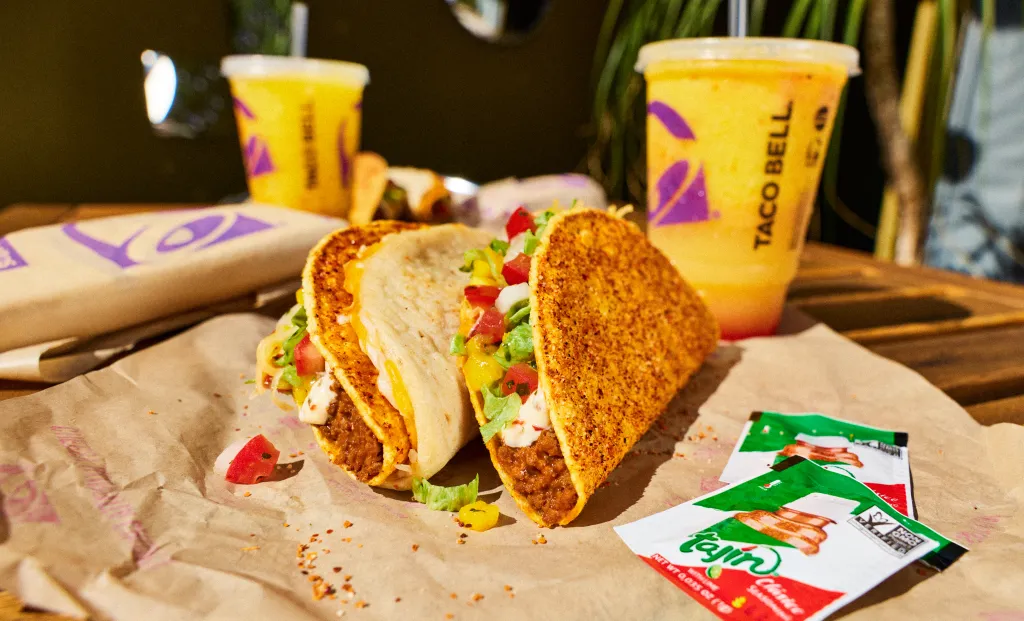 Taco Bell tacos and drinks, with Tajin packets and a Peso Pluma partnership.
