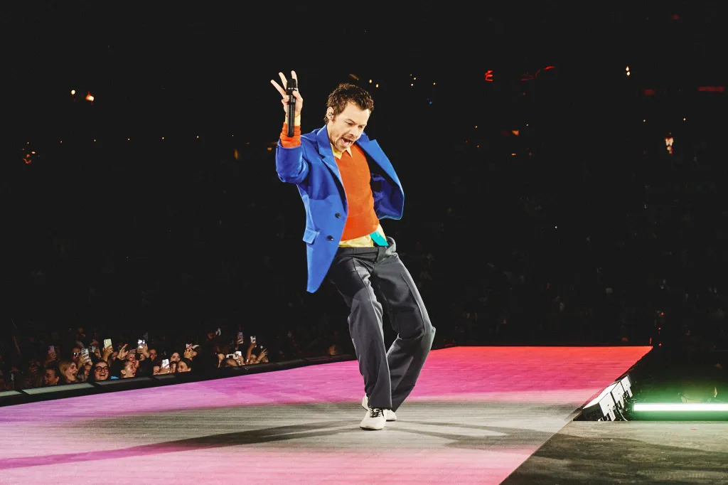 Harry Styles performing on stage.