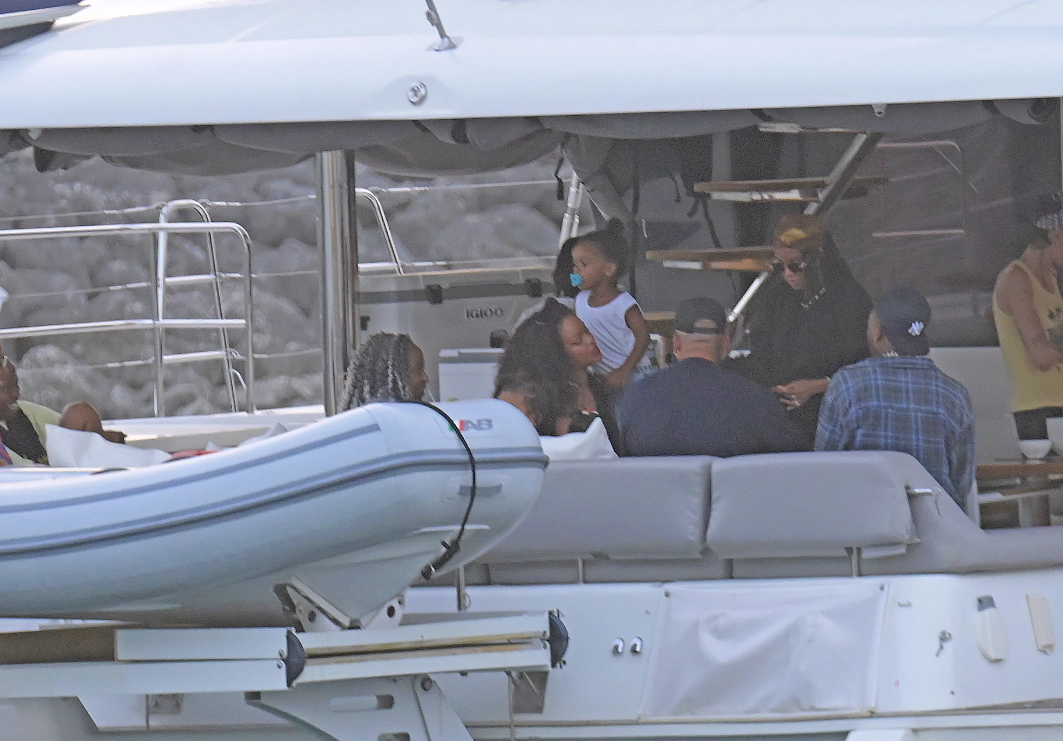 Rihanna with her children and other people on a catamaran.