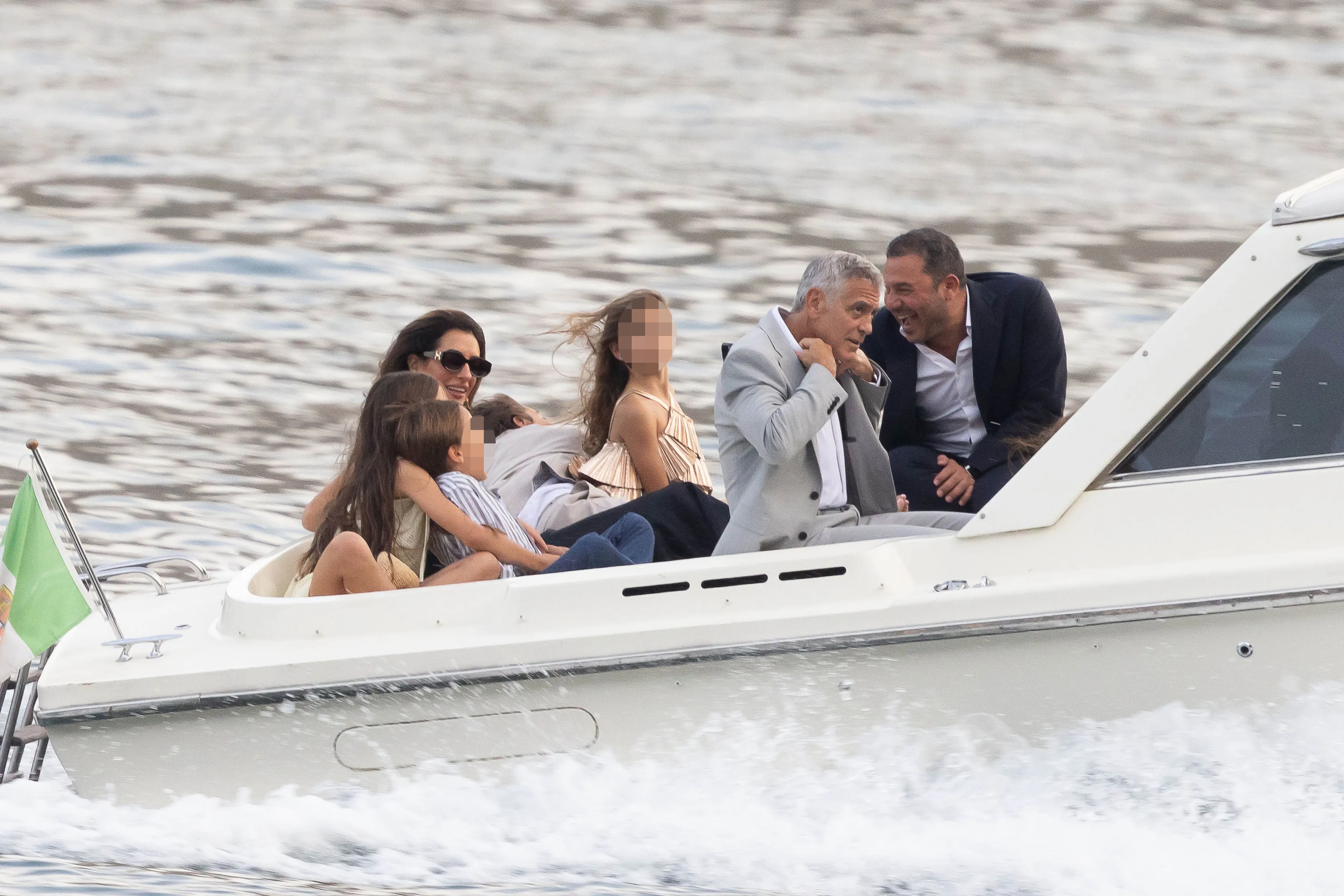 George Clooney, Amal Clooney, and their twins, Ella and Alexander, arrive by boat for a fundraising dinner.