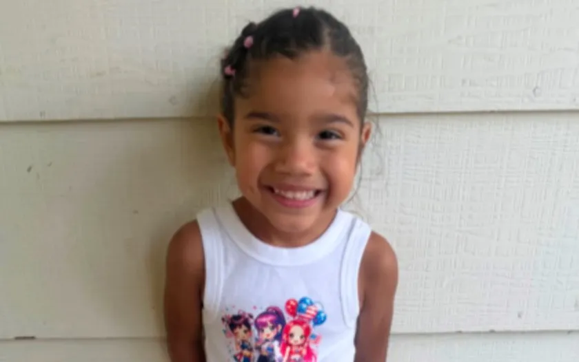 Portrait of Lailah, a smiling 3-year-old girl.