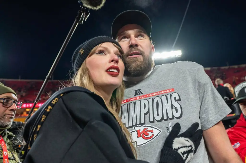 Taylor Swift and Travis Kelce looking up at an event.