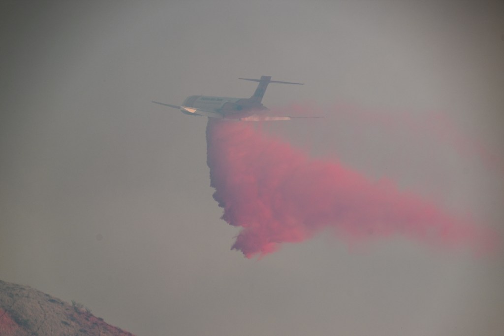 A fire plane releases fire retardant over the "Timber Fire" in Big Sur, California.