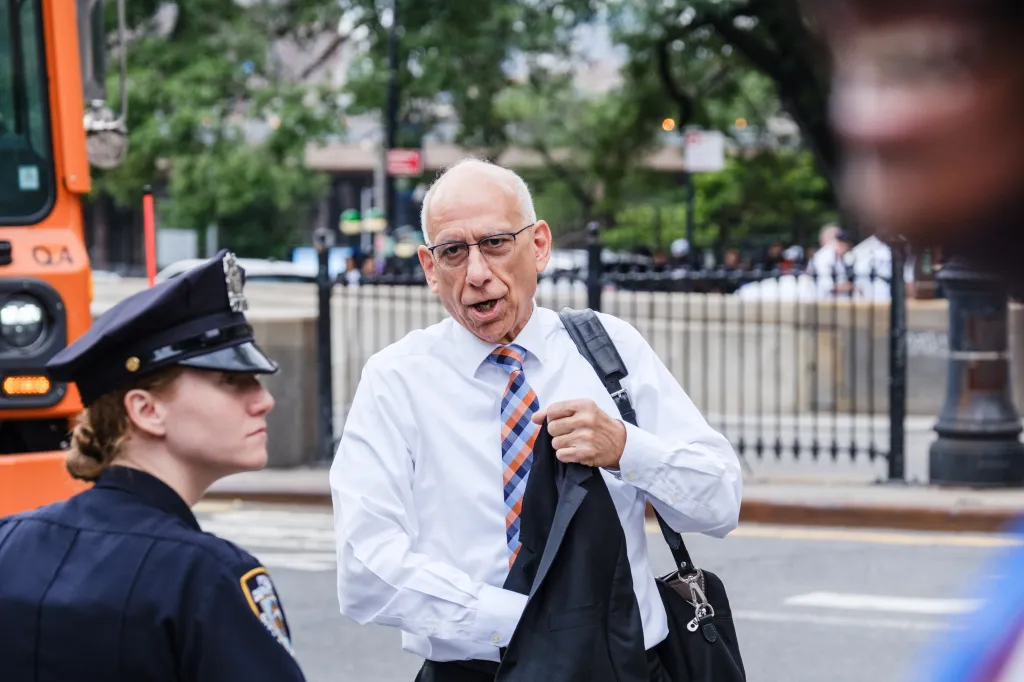 First Deputy Mayor Dean Fuleihan speaking to a police officer.