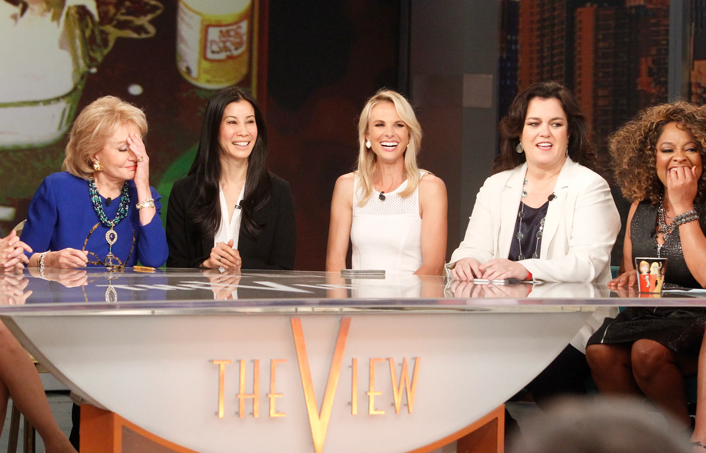 Five co-hosts of "The View" sitting at a desk with "THE VIEW" logo visible.