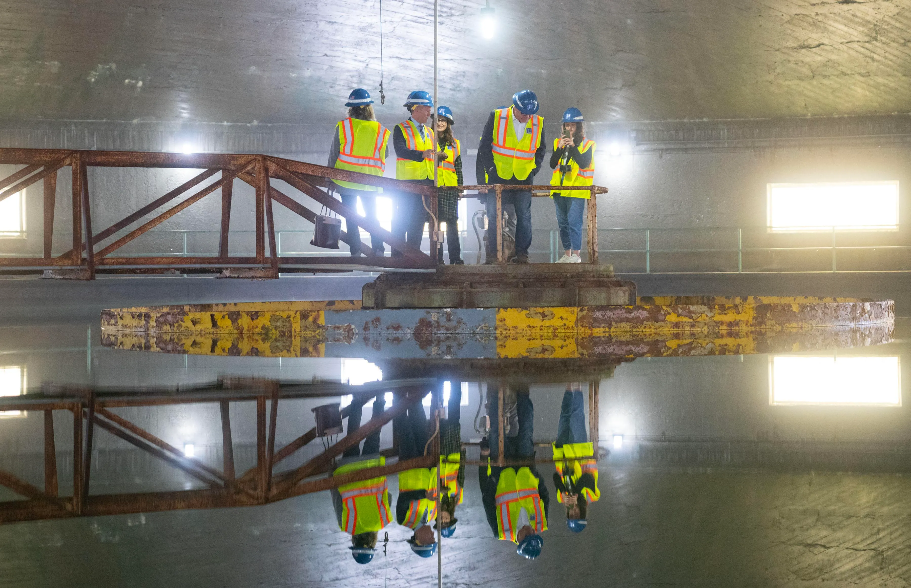 A group including Governor Tim Walz, Lieutenant Governor Peggy Flanagan, Saint Paul Mayor Melvin Carter and General Manager Patrick Shea stand in the center of a lime softening clarifier during a tour of McCarrons Water Treatment Plant on January 26, 2023 at St. Paul Regional Water Services in Maplewood, Minn. A group including Governor Tim Walz, Lieutenant Governor Peggy Flanagan, Saint Paul Mayor Melvin Carter and General Manager Patrick Shea stand in the center of a lime softening clarifier during a tour of McCarrons Water Treatment Plant on January 26, 2023 at St. Paul Regional Water Services in Maplewood, Minn.