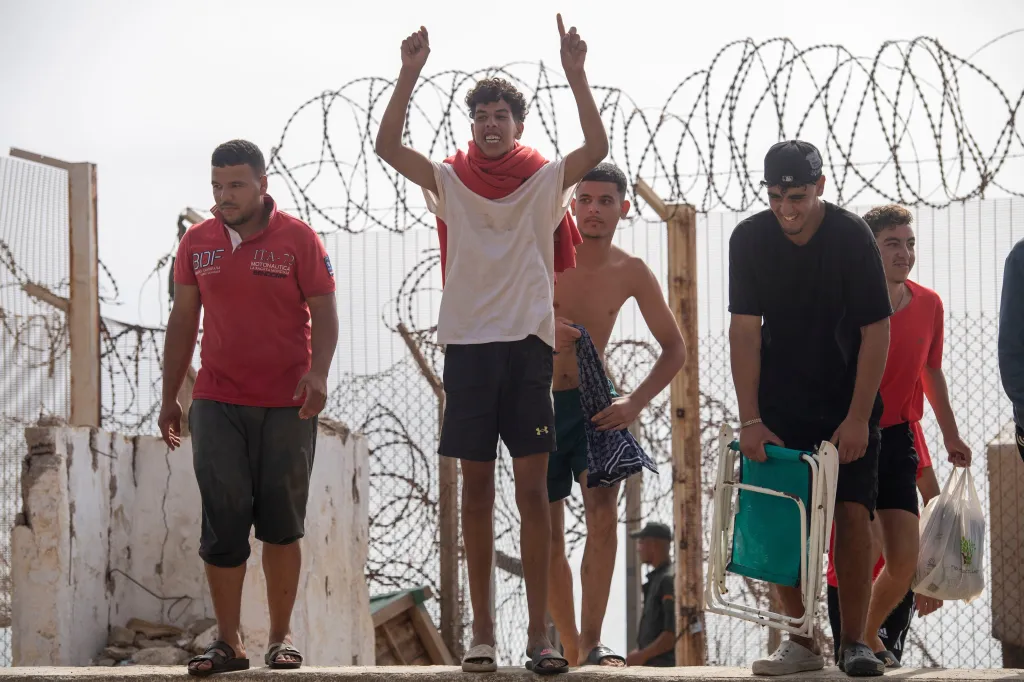 Undocumented migrants who returned from the Spanish enclave of Ceuta gather at the Bab Sebta border crossing near Fnideq, Morocco.