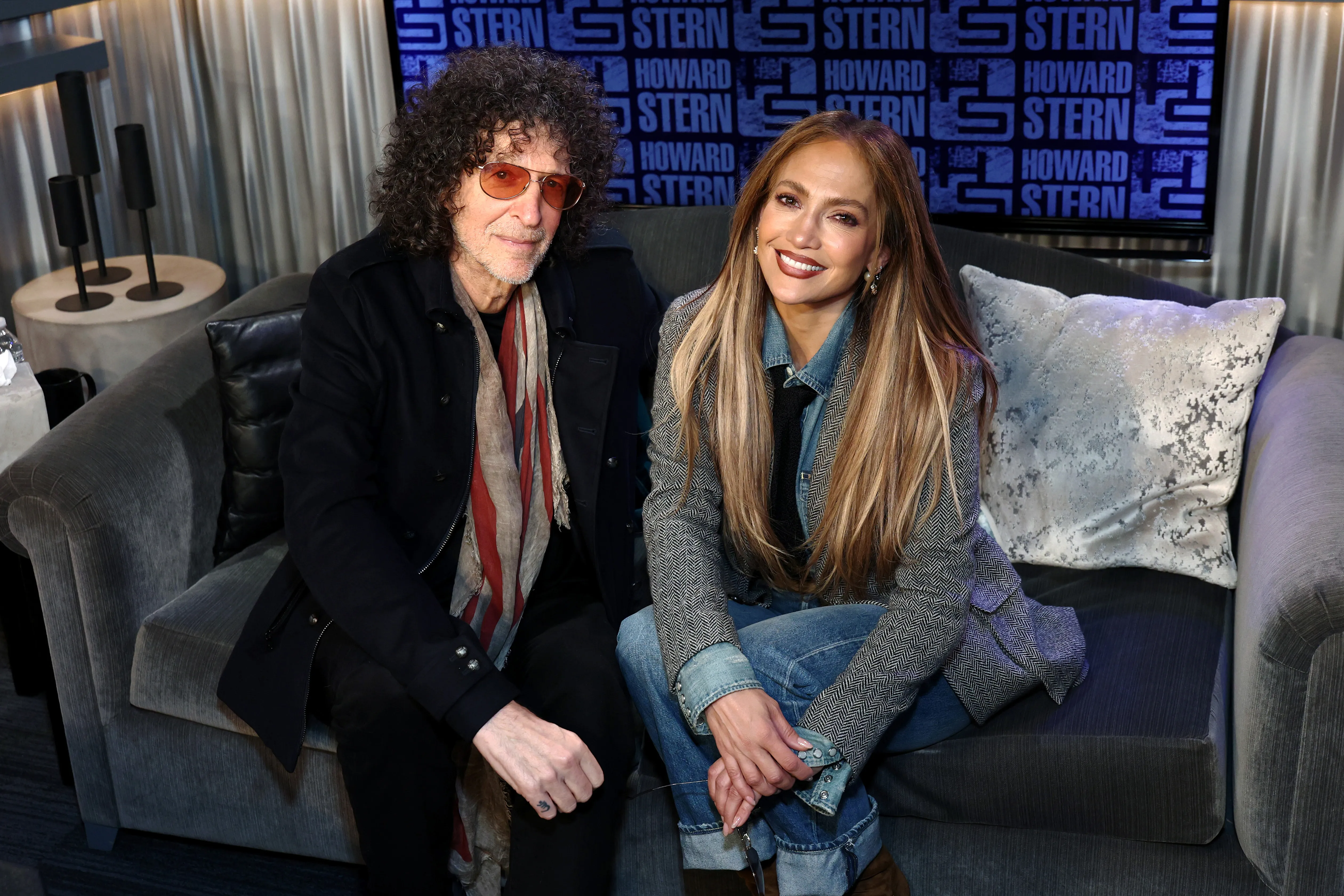 Howard Stern poses for a photo with Jennifer Lopez