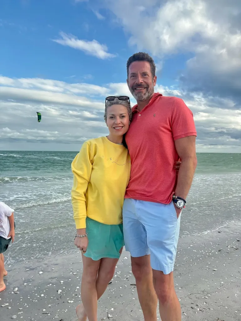 Kristopher and Amanda Karolkiewicz standing on a beach.