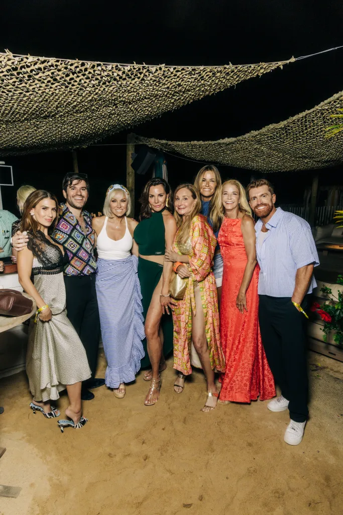 A group of nine people posing for a photo at Page Six's VRT Out East Party.