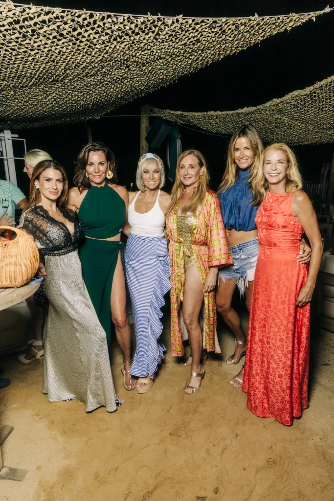 Six women posing at an event.