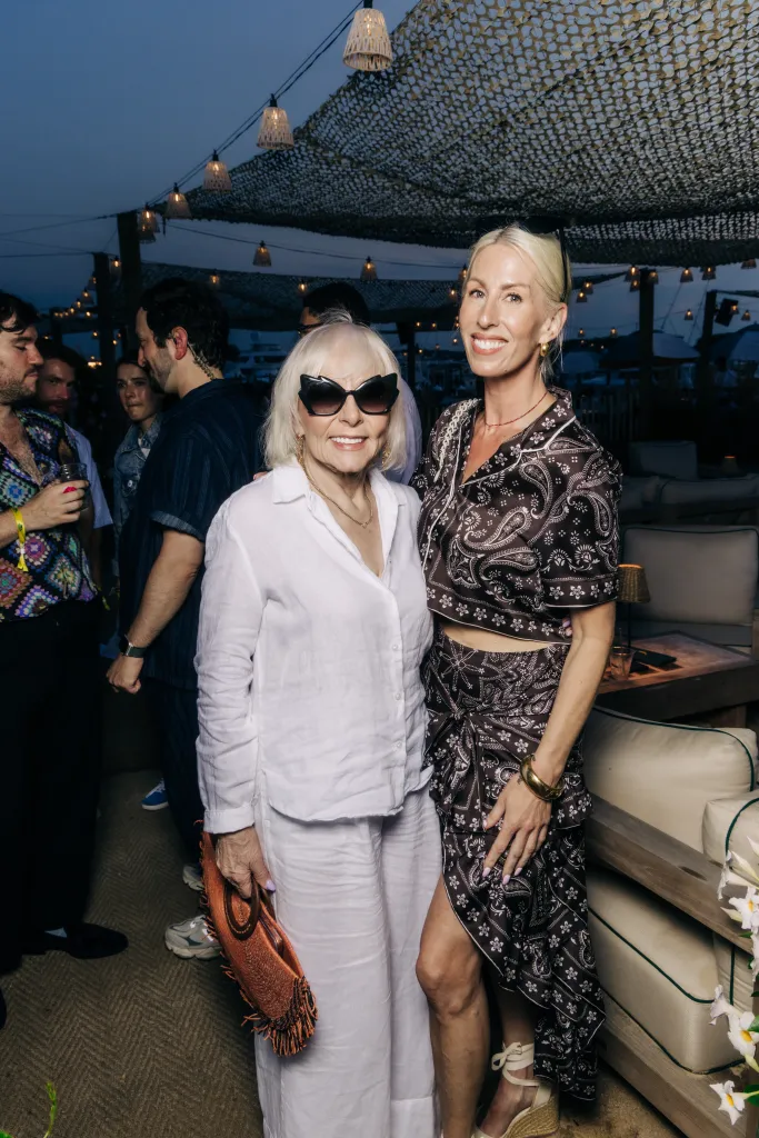 Two women smile at the camera at the Page Six's VRT Out East Party.