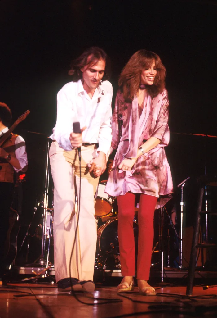 James Taylor and Carly Simon performing on stage.