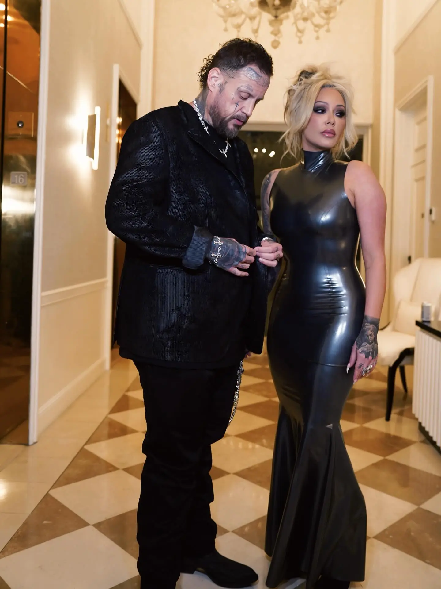 Jelly Roll and Bunnie XO in formal attire, holding hands.