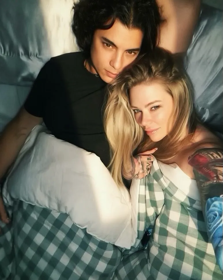 Jenna Jameson and Mil R. Ocampo lying in bed together.
