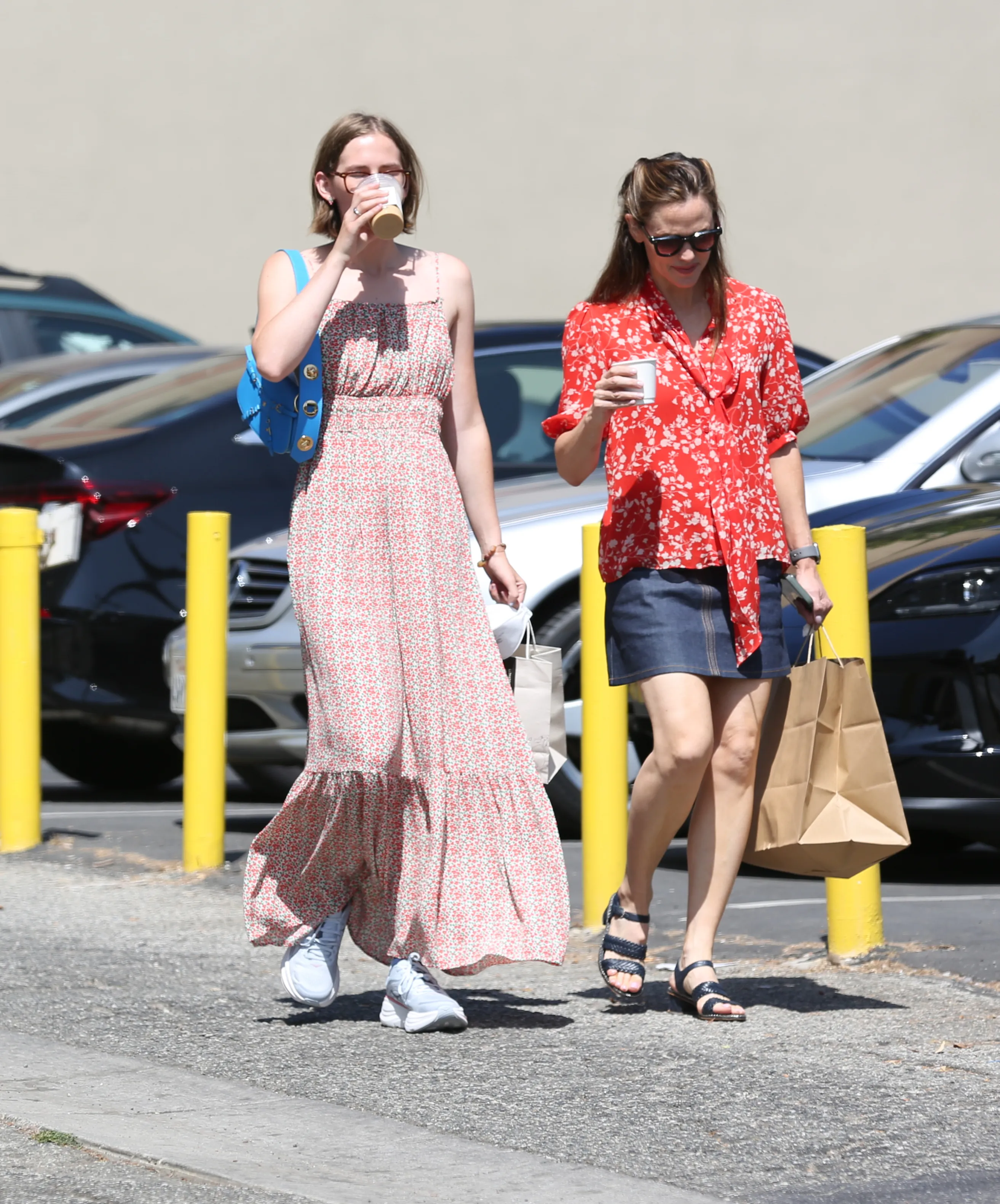 Jennifer Garner and Violet Affleck walk side by side, each carrying a drink.