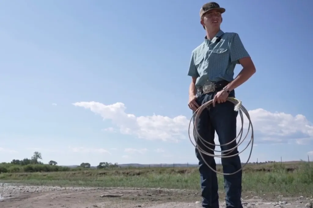 Jory Thomas holding a lariat with the Yellowstone River in the background.