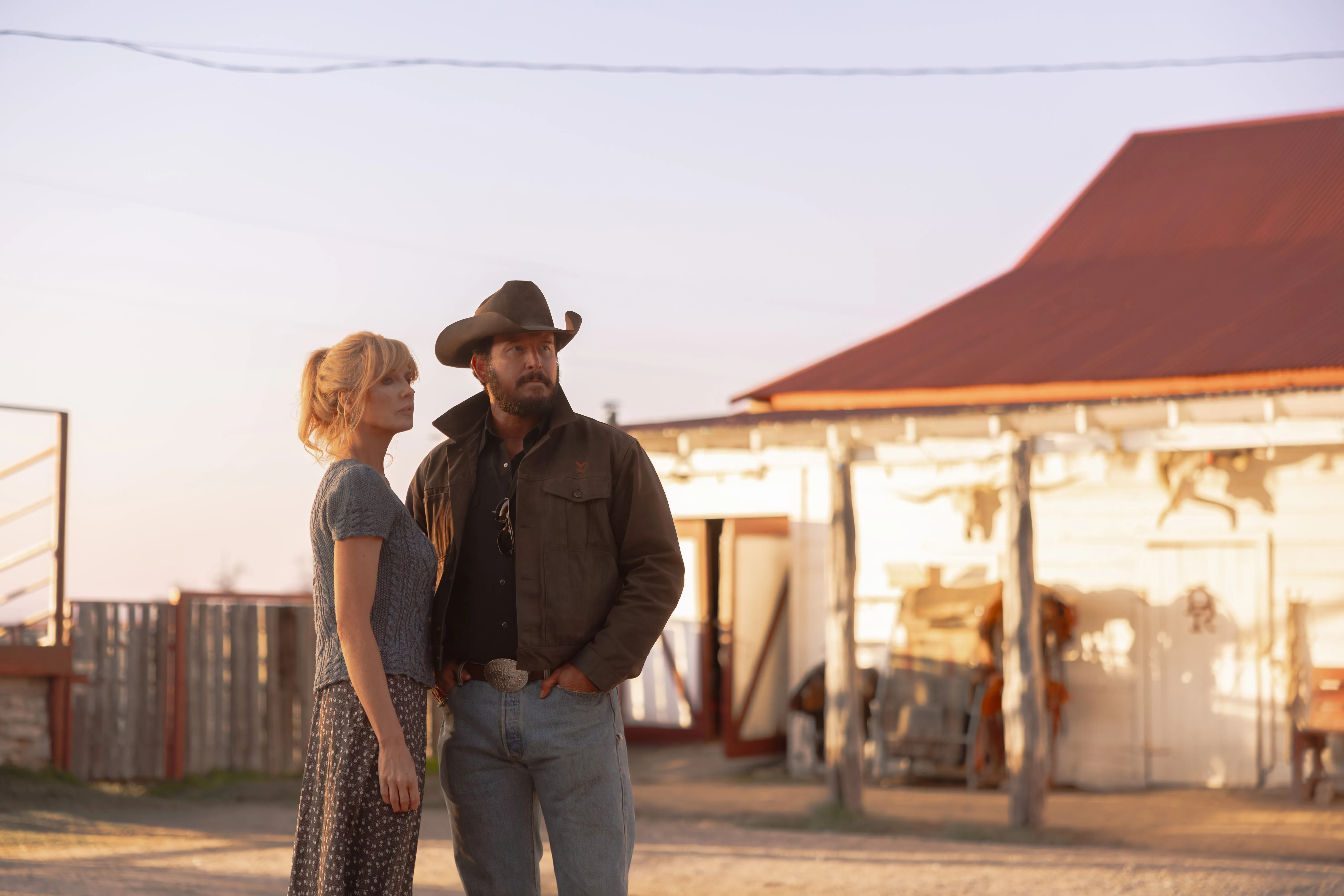 Beth Dutton and Rip Wheeler looking into the distance at Dutton Ranch.