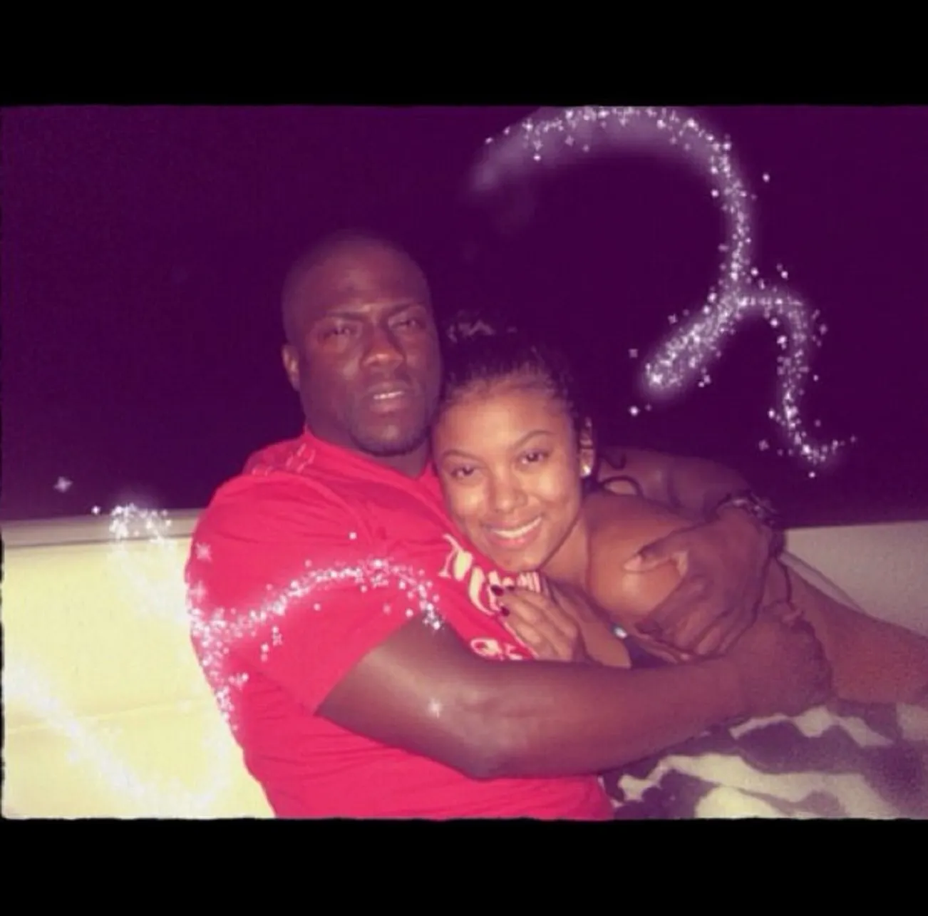 Kevin and Eniko Hart embracing.