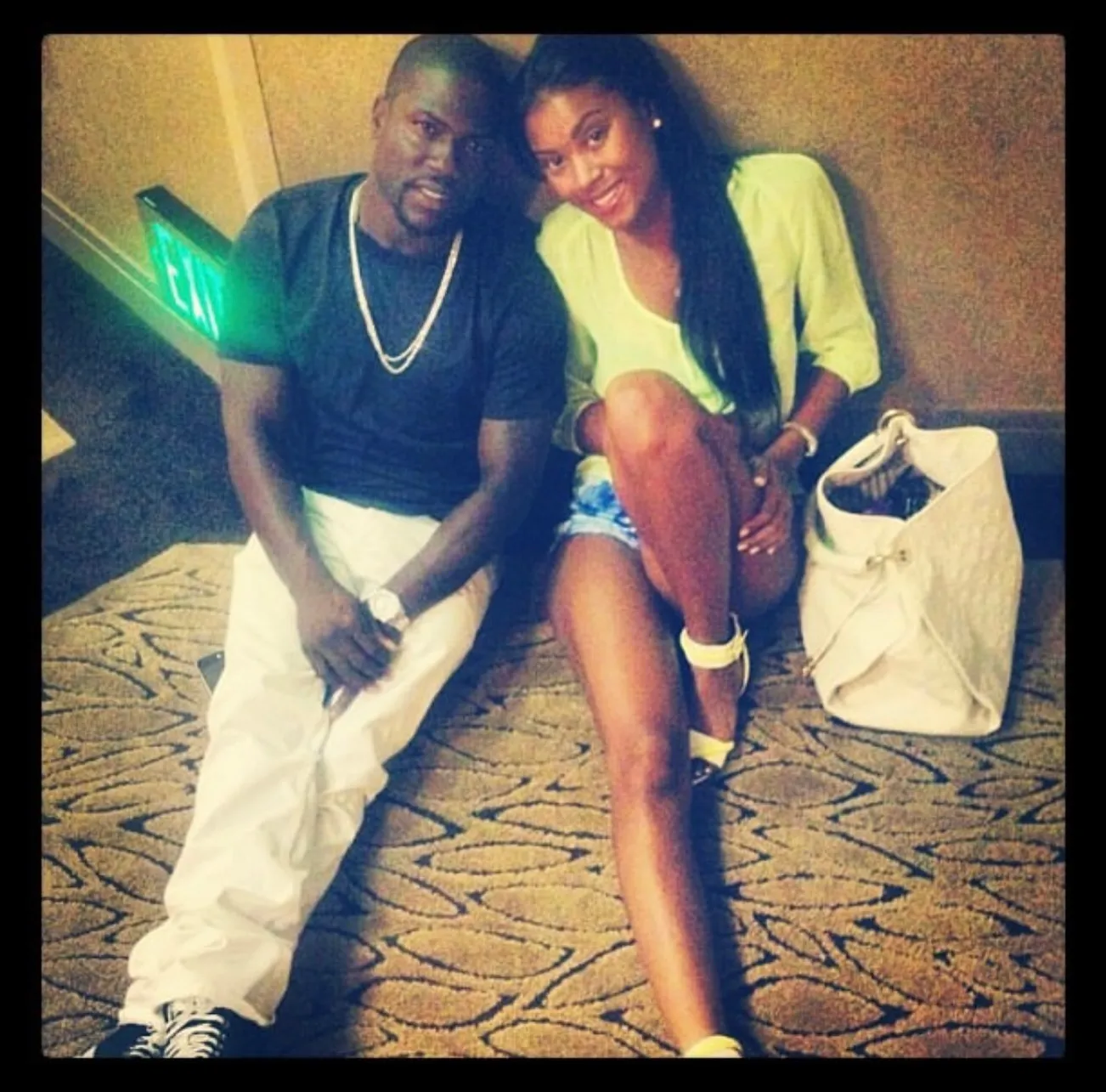 Kevin and Eniko Hart seated on the floor.