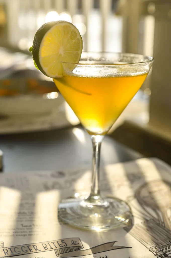 Six Tentacles cocktail with a lime garnish at Lamplight Lounge.