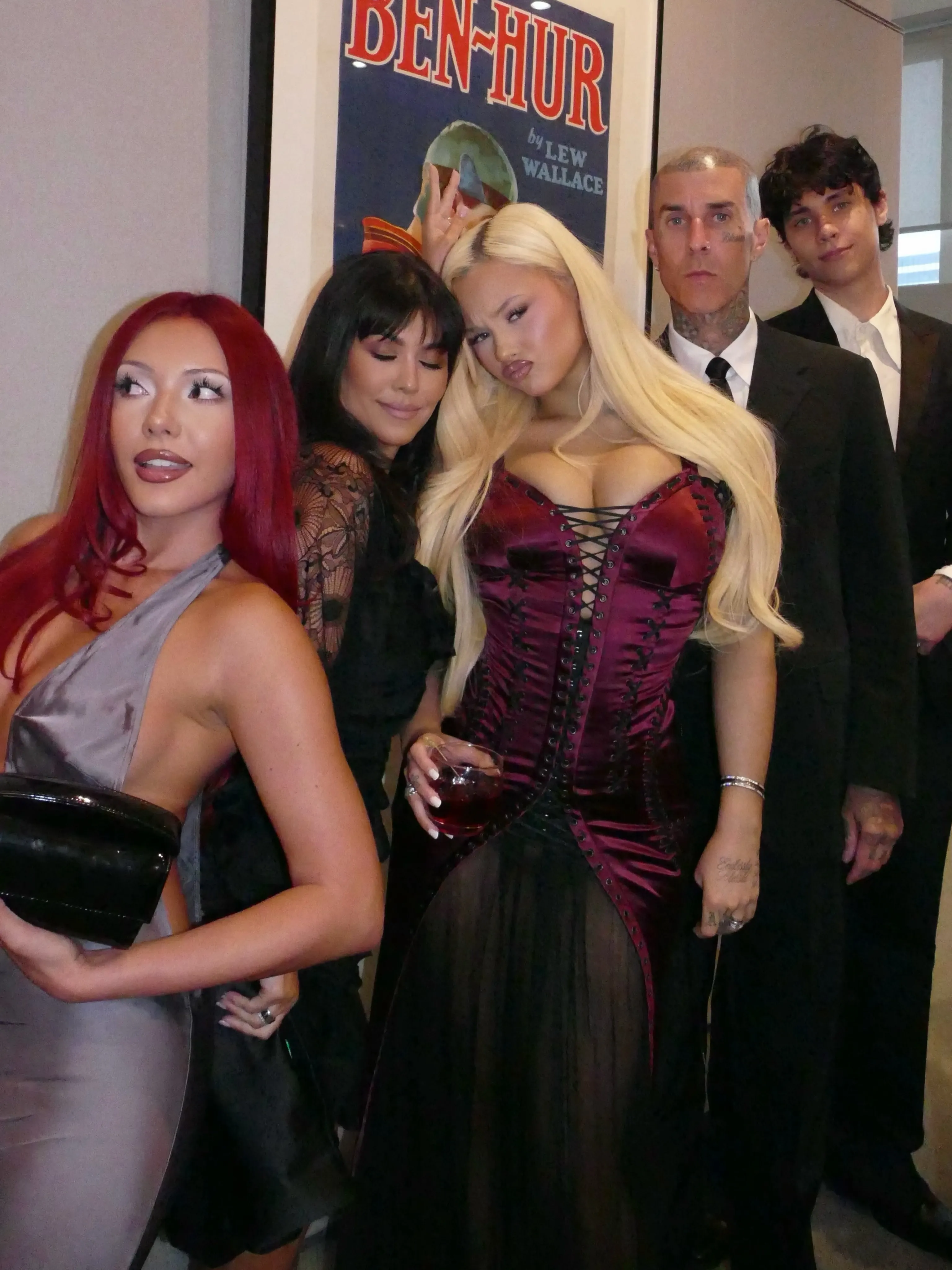 Kourtney Kardashian, Travis Barker, and family dressed in Halloween costumes.