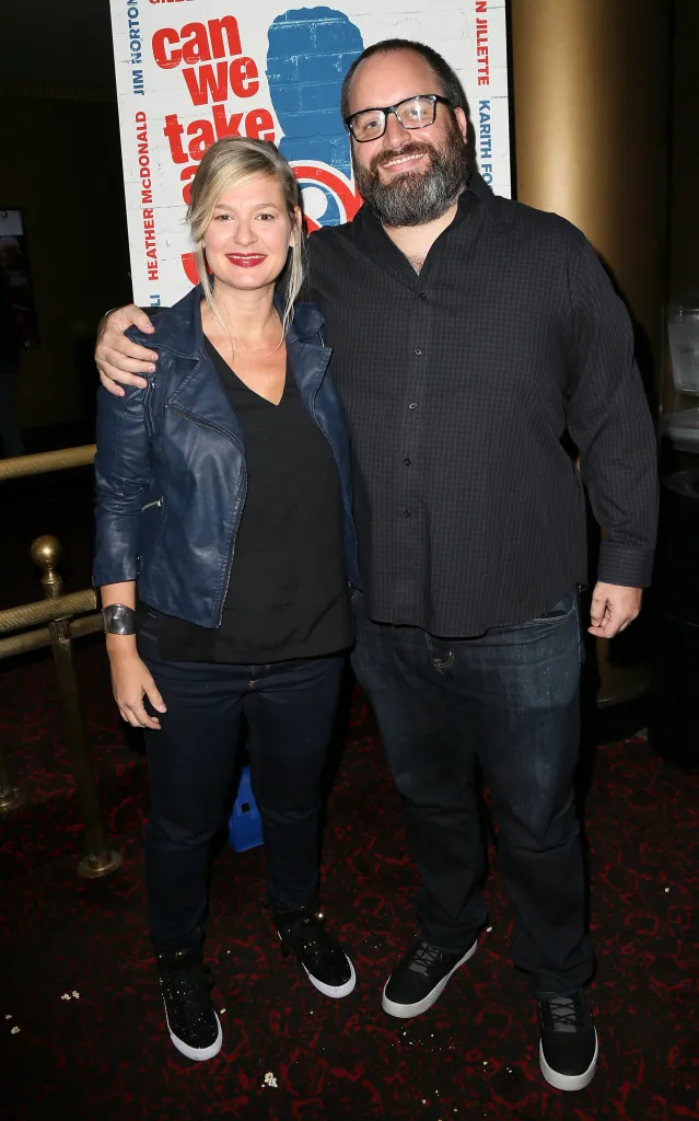 Comedians Christina Pazsitzky and Tom Segura pose together at a film premiere.