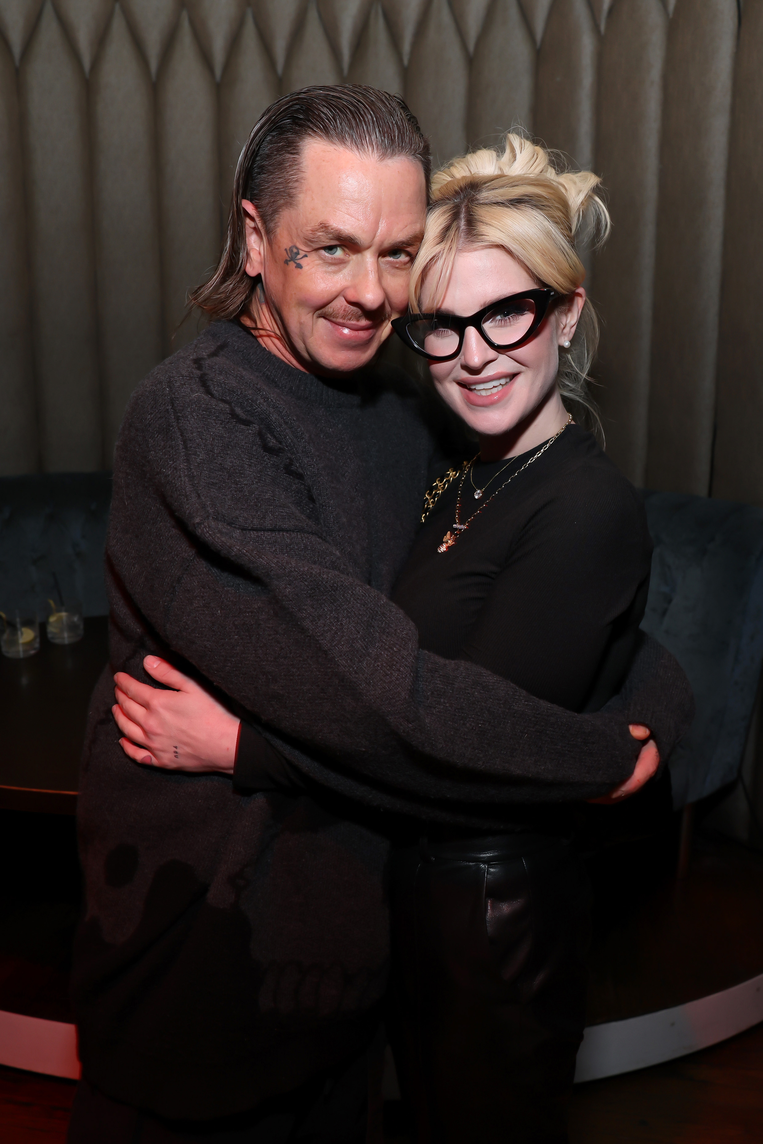 Sid Wilson and Kelly Osbourne embrace at the Matt Mathews "Boujee On A Budget" tour celebration.