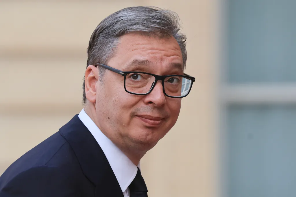Serbia's President Aleksandar Vucic wearing a suit and glasses, looking towards the camera.