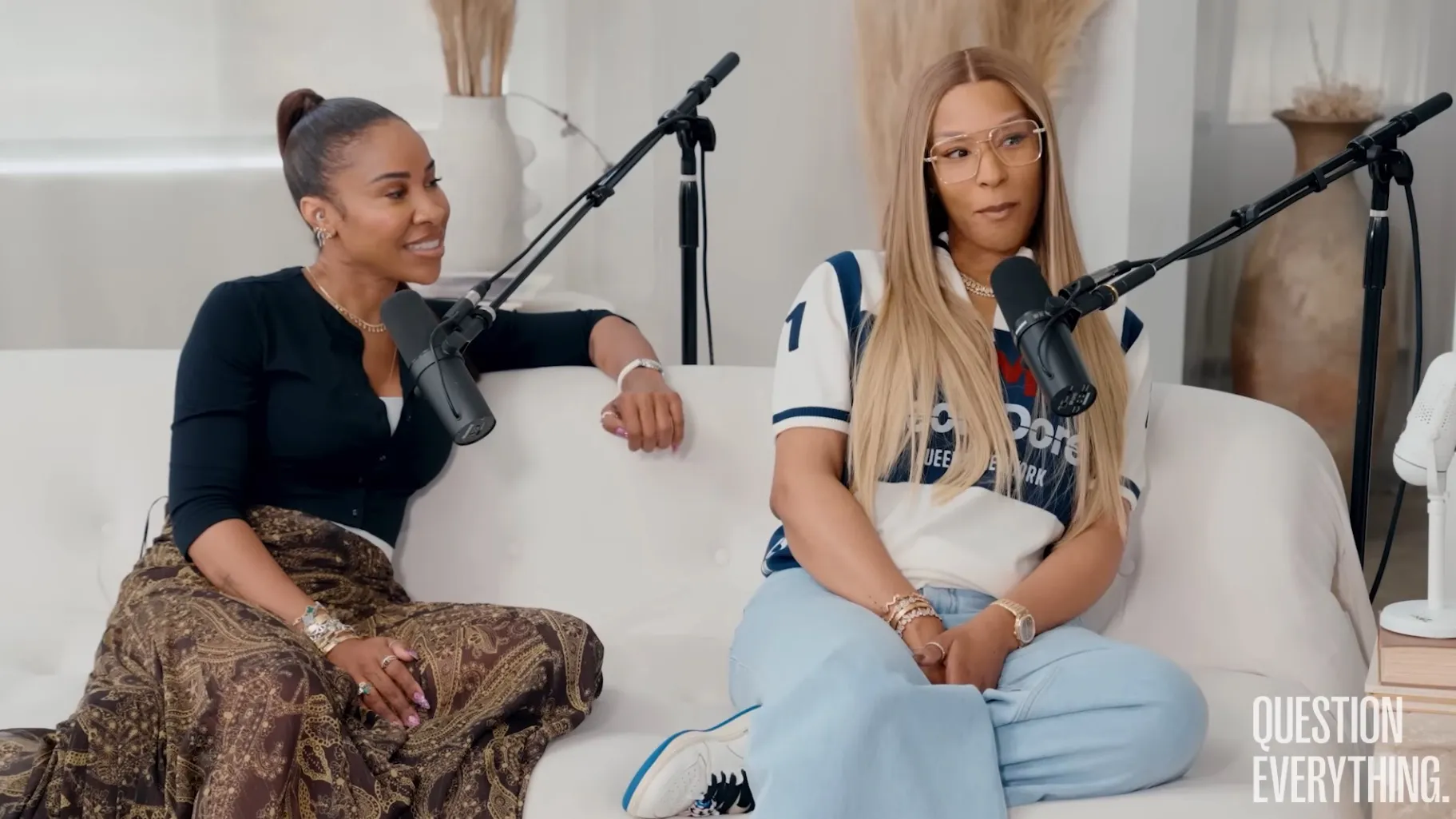 Savannah James and Amy McDaniel seated on a white sofa with microphones in front of them.