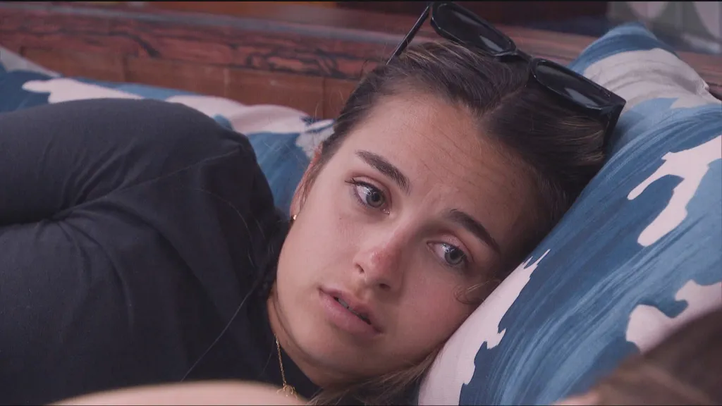 Lyric Medeiros lying on a pillow, looking contemplative.