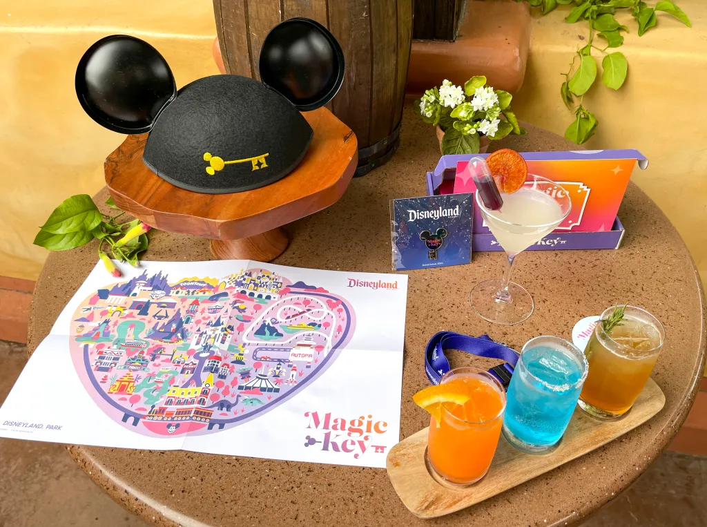 Magic Key items including a Mickey Mouse ear hat, map, pin, and specialty drinks.