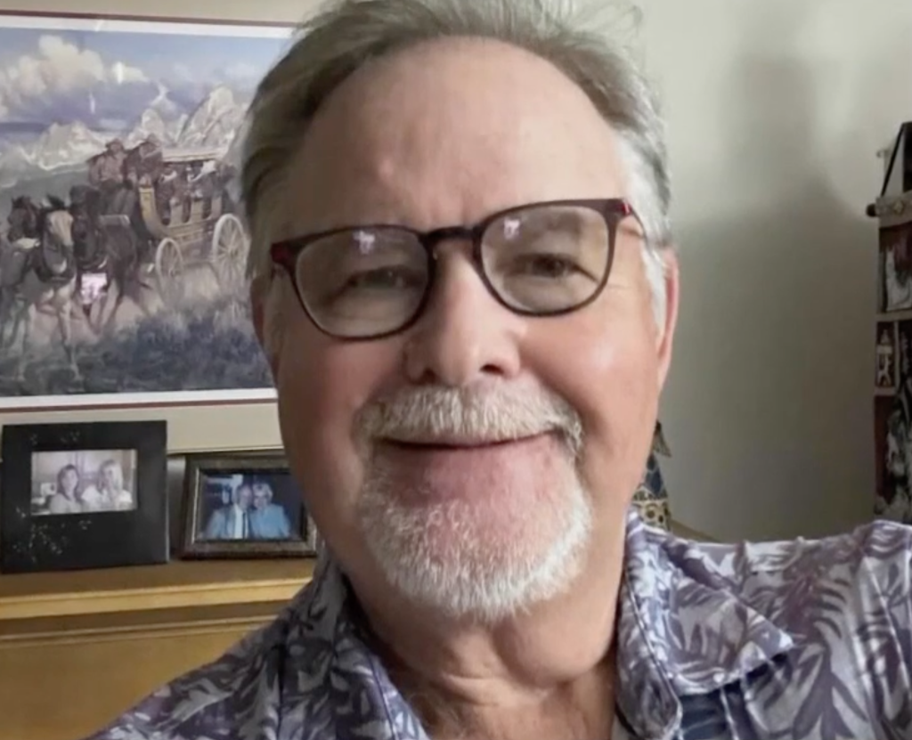Todd Stewart smiling and wearing glasses.