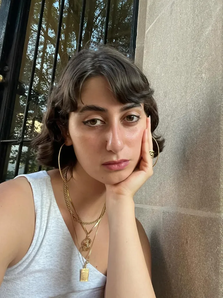 Rama Duwaji, wife of Mayor Zohran Mamdani, wearing multiple gold necklaces and large hoop earrings.