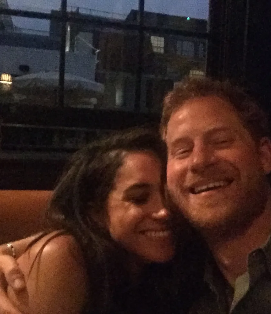 Meghan Markle and Prince Harry smiling and embracing.